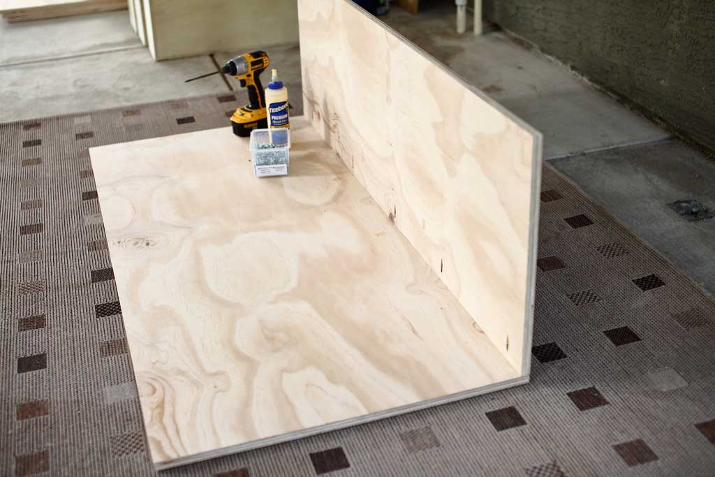 attaching side plywood to the backboard of the DIY closet organizer