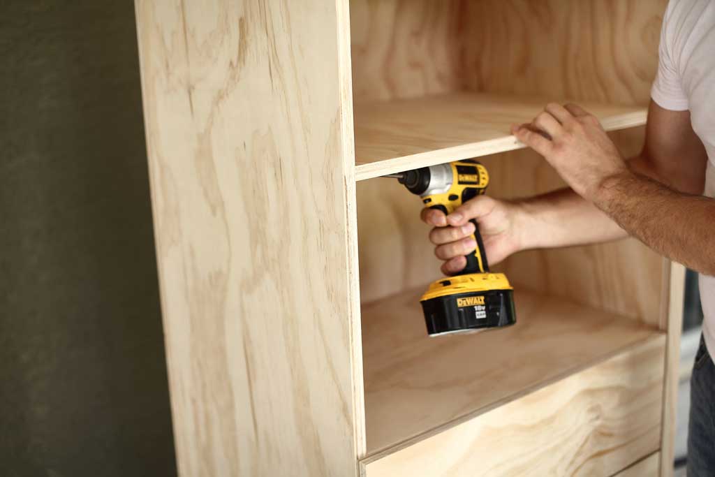 attaching shelves to the DIY closet organizer