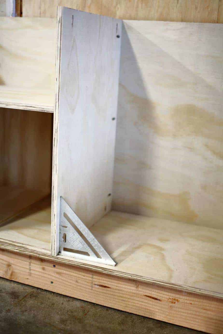 making sure the side piece is squared for the DIY Garage Cabinets