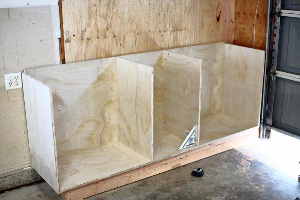 installing the middle pieces of the DIY Garage Cabinets