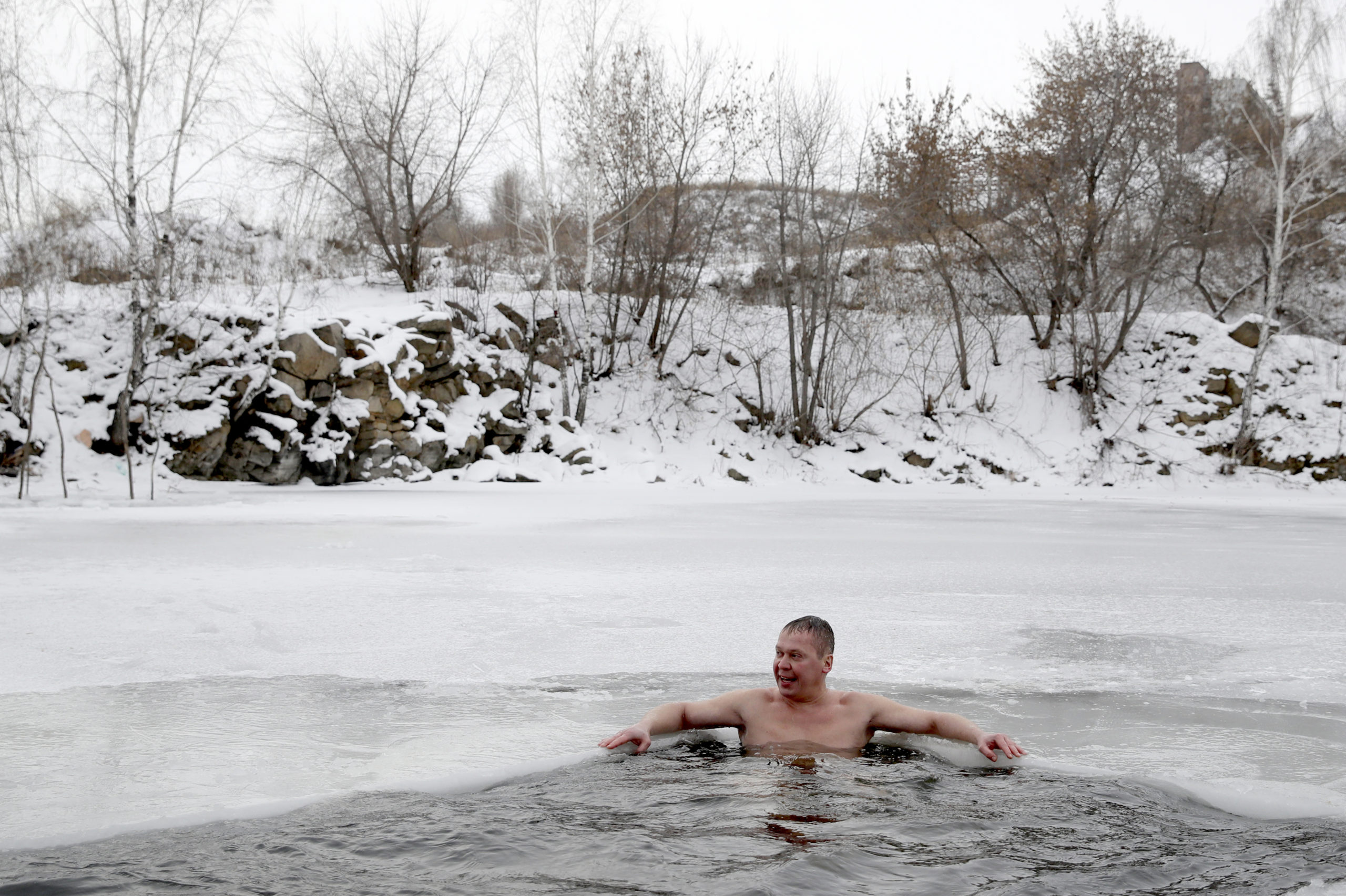 man sitting in hot water spring