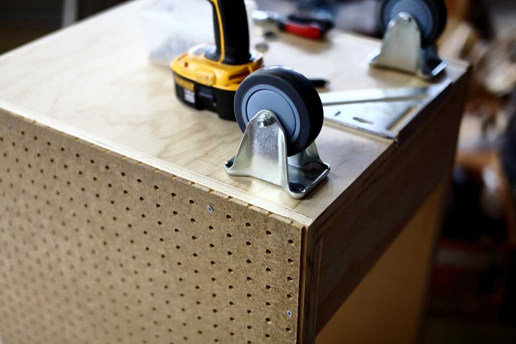 installing wheels on the DIY Mobile Tool Cart with Pegboard