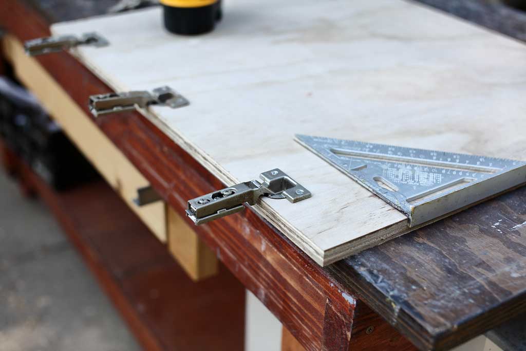 attaching door hinges to the cabinet doors