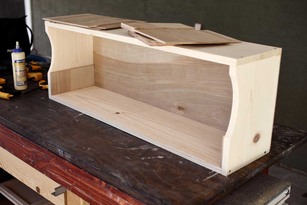 gluing the shelf supports to the sides of the shelf board