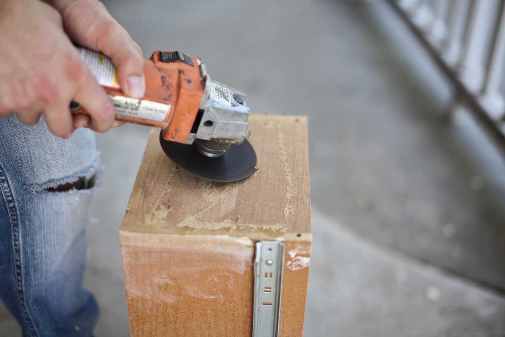 using grinder to cut off staples from drawer