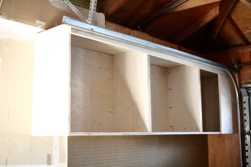 attaching the top piece of the garage cabinets