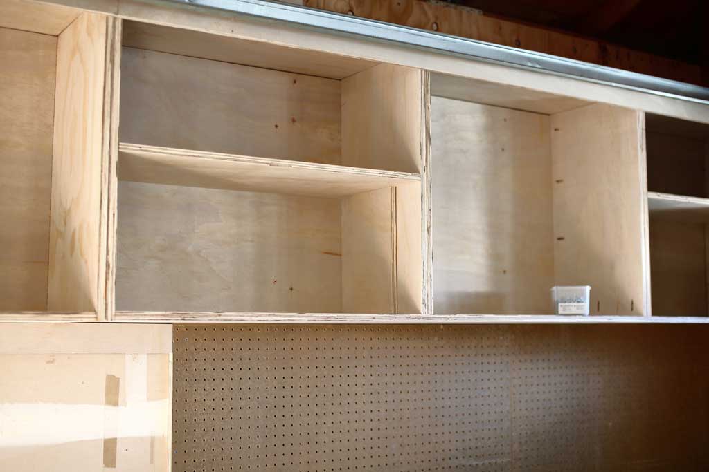 installing the shelves of the attaching the top piece of the garage cabinets