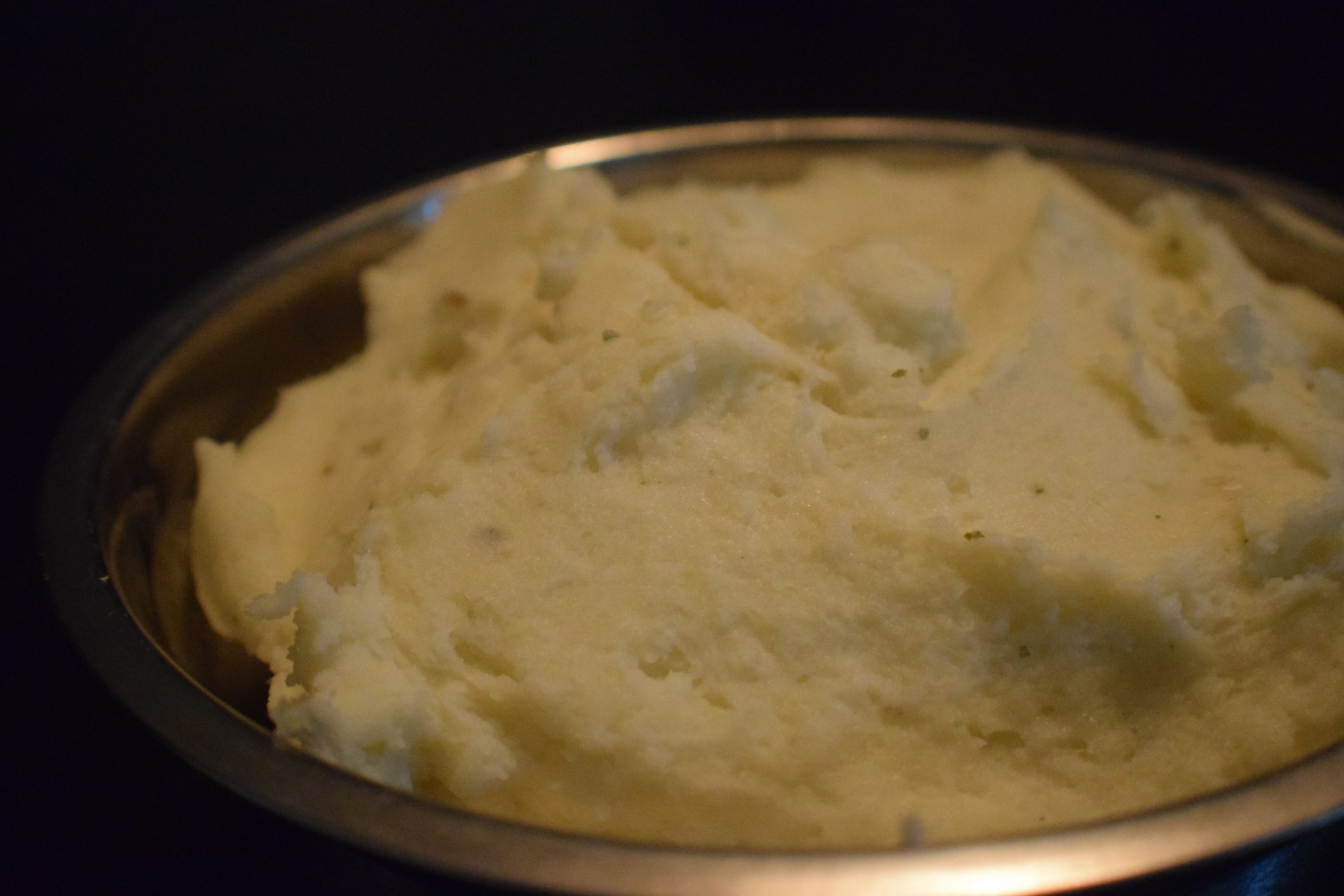 mashed potatoes in a bowl in a dark room