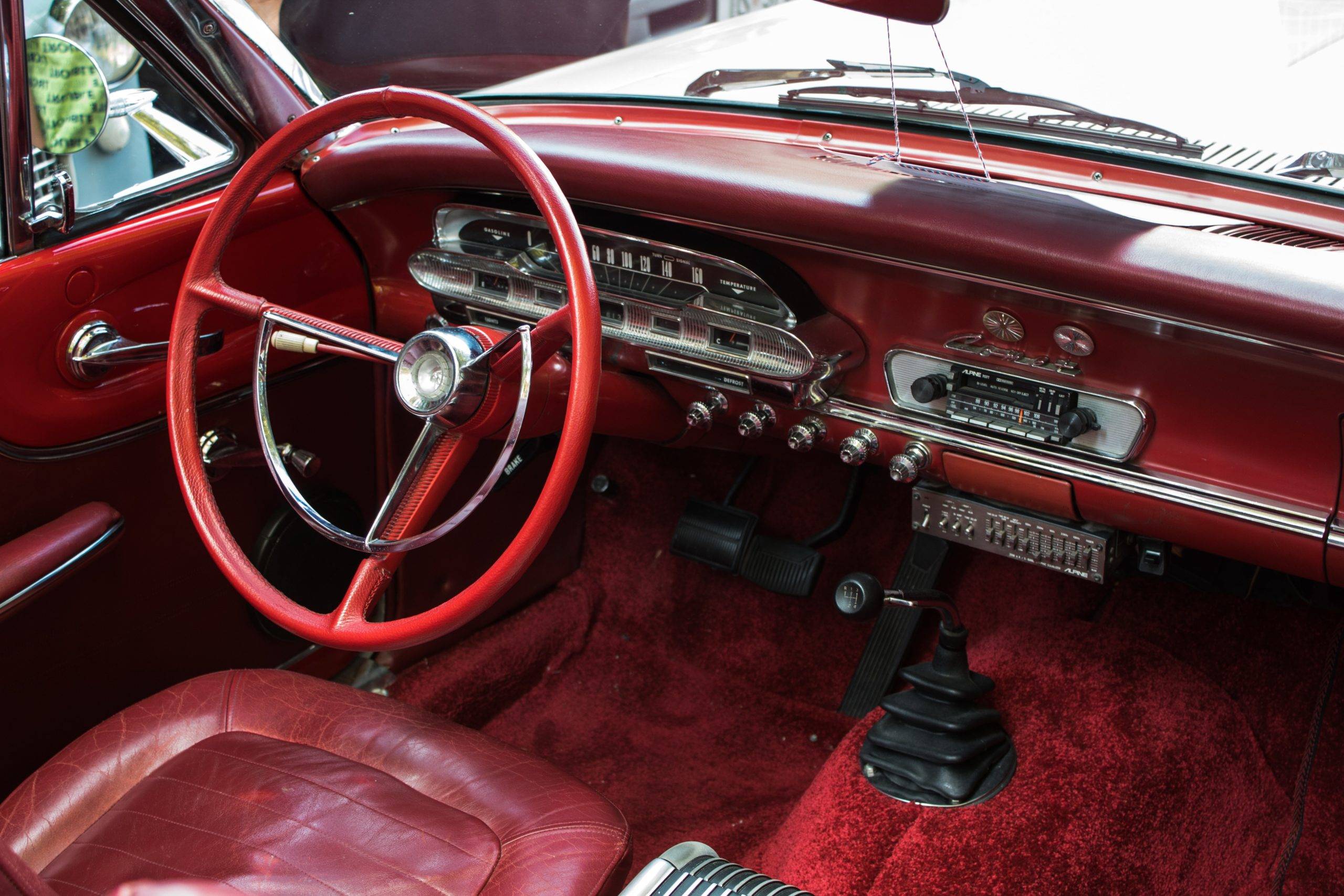 Red car interior with large red steering wheel