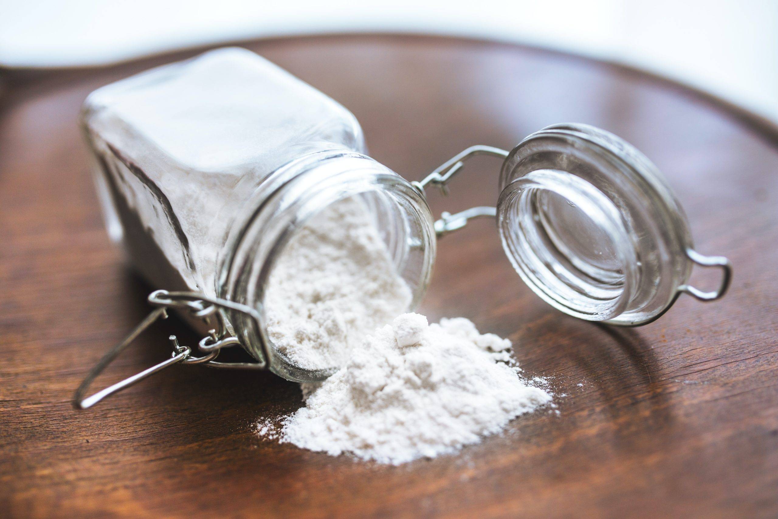 White powder scattered on a table from jar