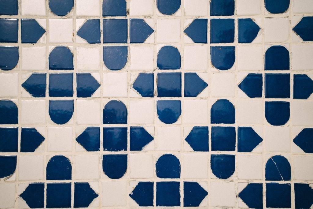 blue and white tile backsplash with white grout