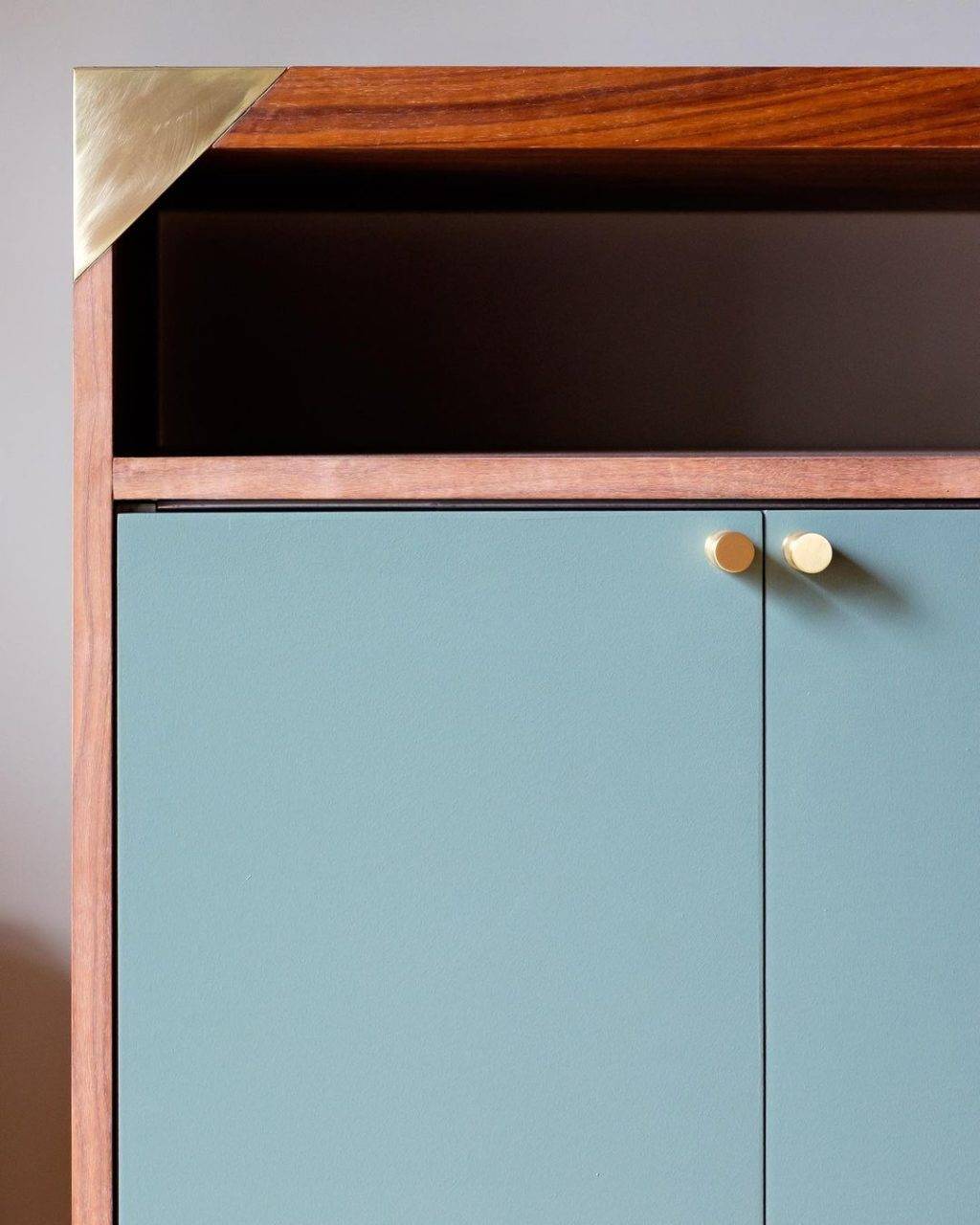 turquoise and wood cabinet with gold knob hardware