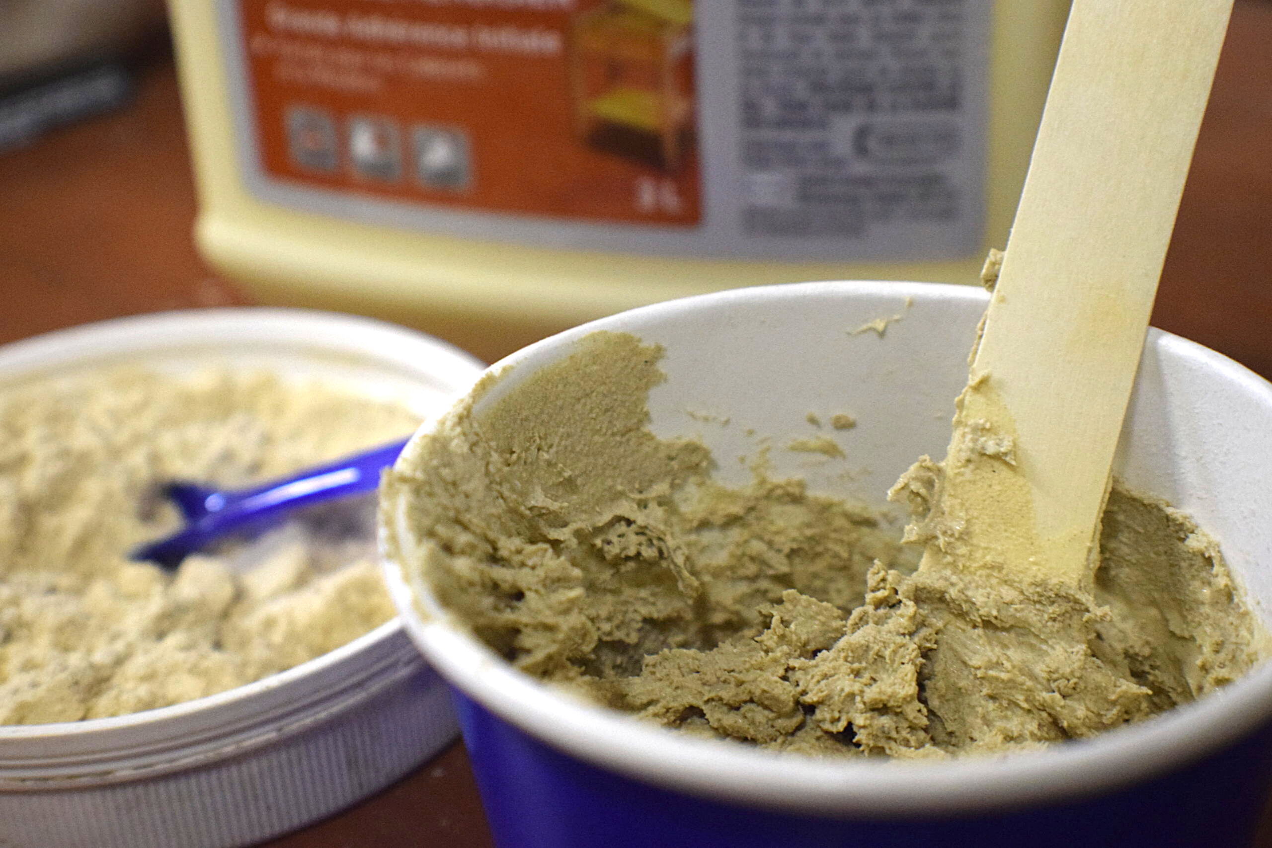 homemade wood filler being mixed in cup