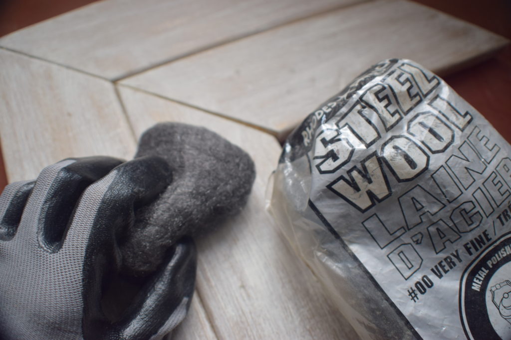 Rubbing steel wool on wood decoration