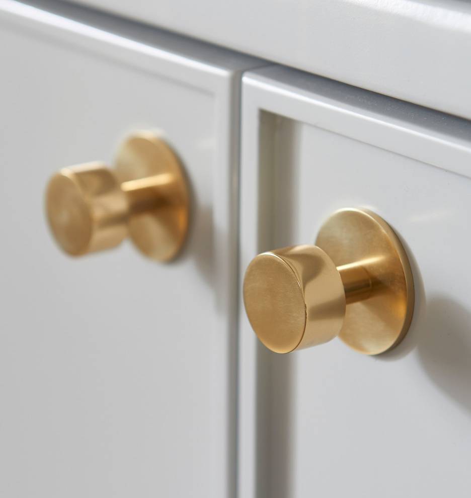 gold round knobs on white cabinets