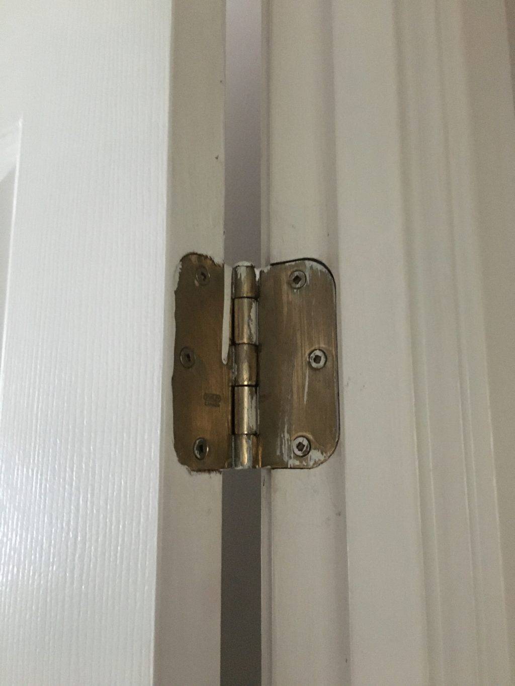 gold door hinge on white door