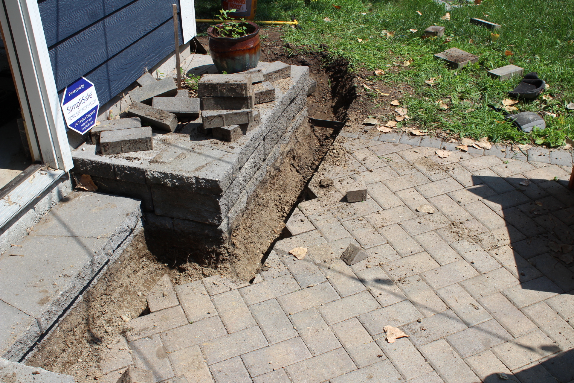 trench dug in front of a house to fit in channel drain