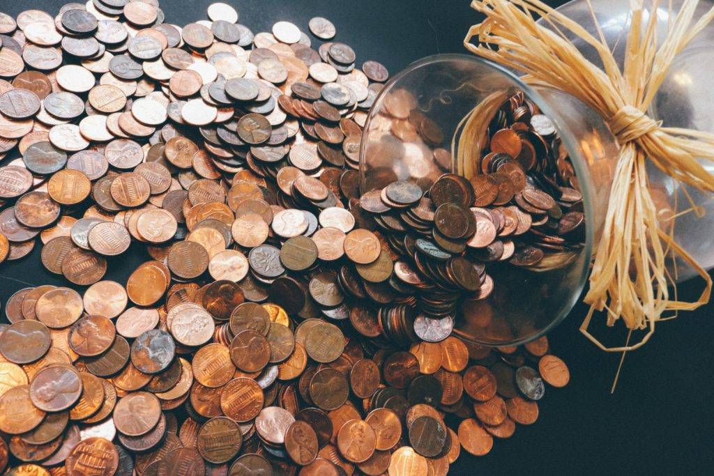 coin jar spilling pennies onto a table