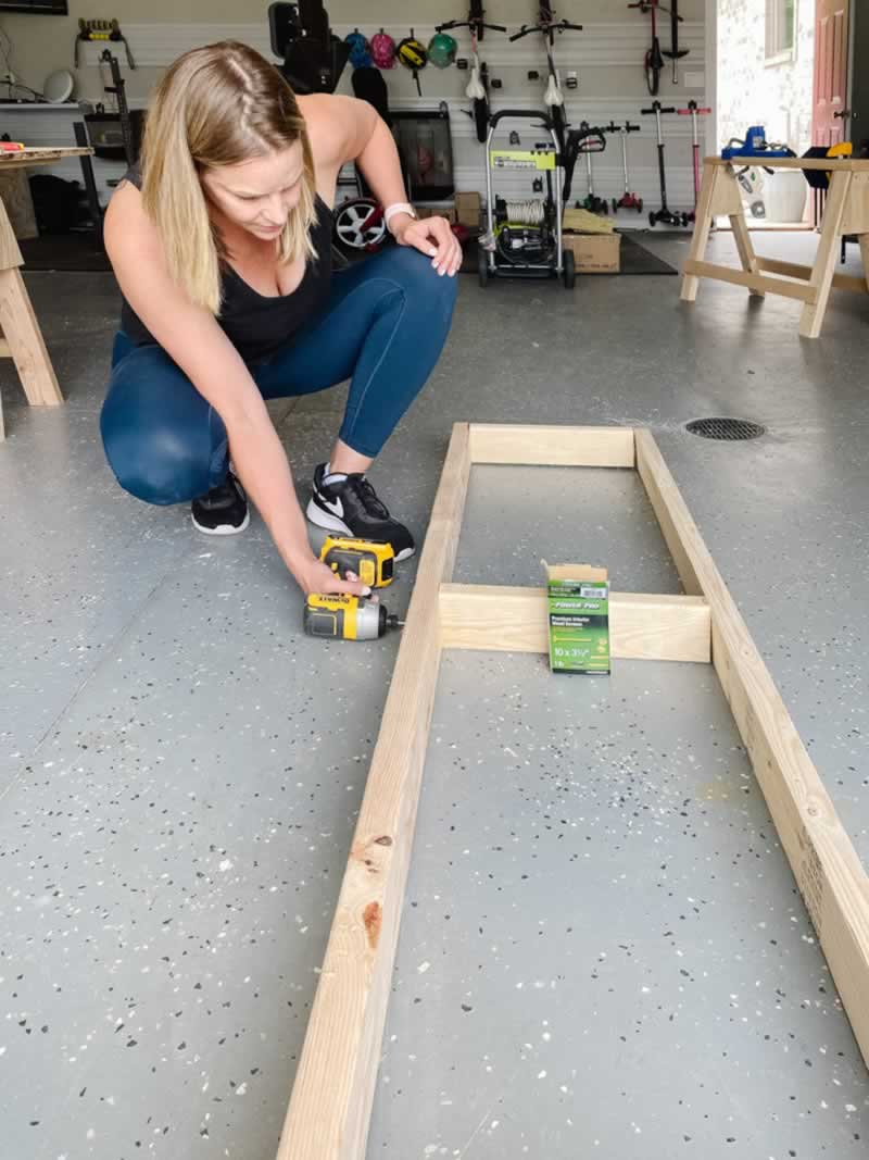 Woman building a cabinet base