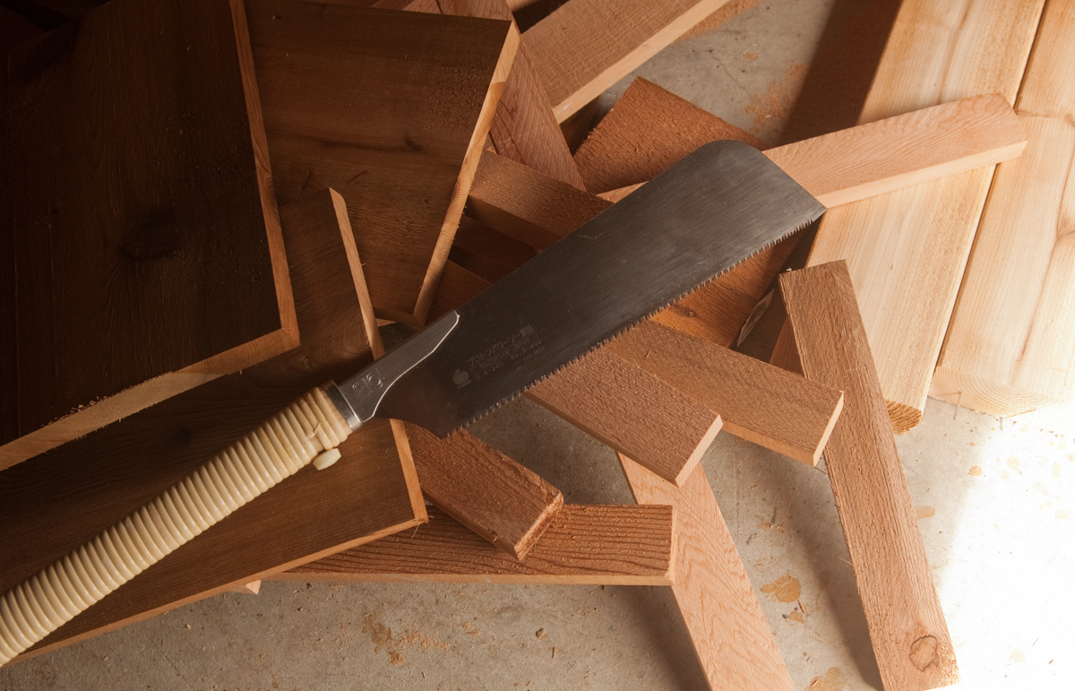 various scrap wood in a pile with a saw