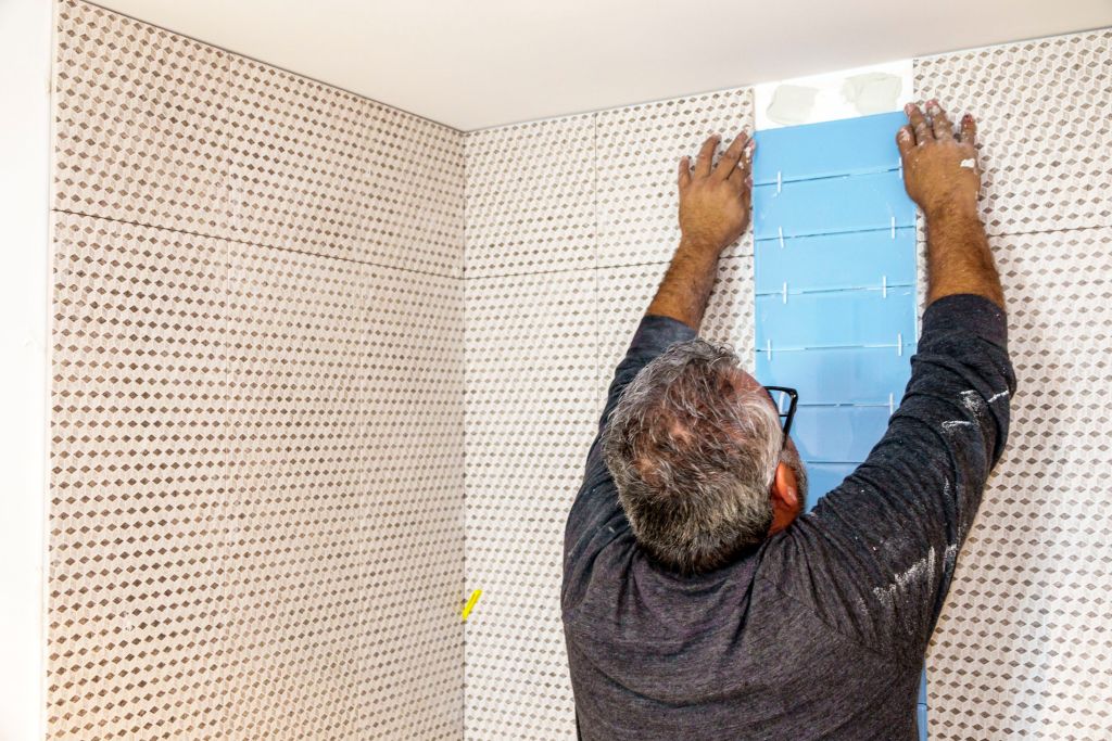 contractor installing bathroom tille