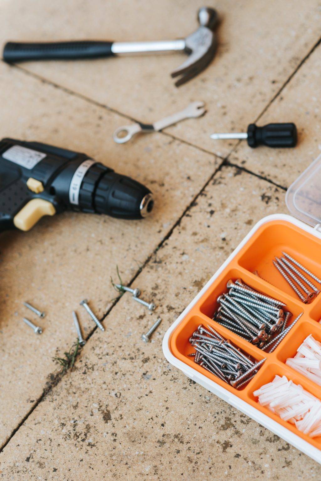 hammer, drill, assorted screws and drywall anchors