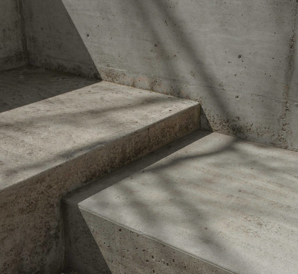 concrete steps and wall with small gouges and imperfections