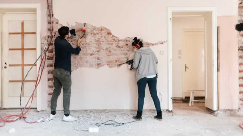 couple demolishing wall