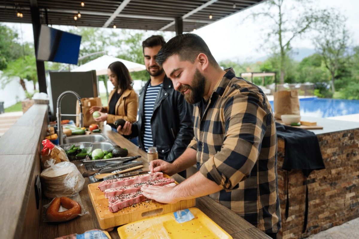 men cooking in outdoor kitchen