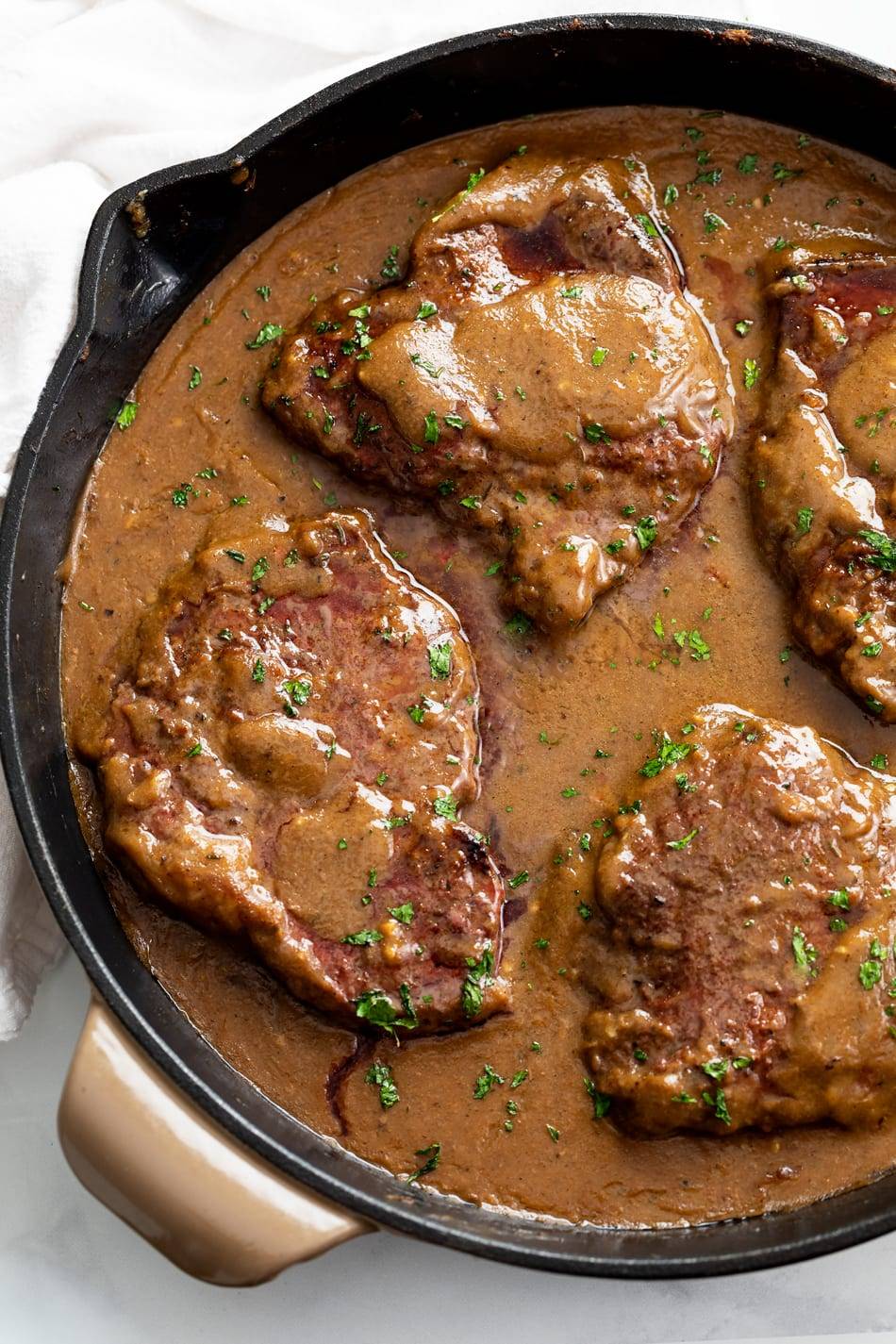 steak with gravy in cast iron skillet