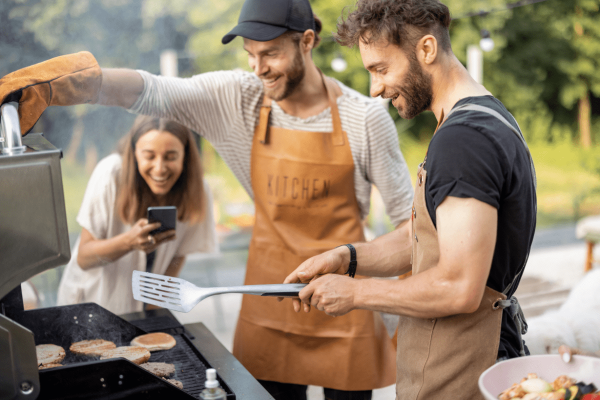 gathered around a bbq cooking outside with friends hamburgers