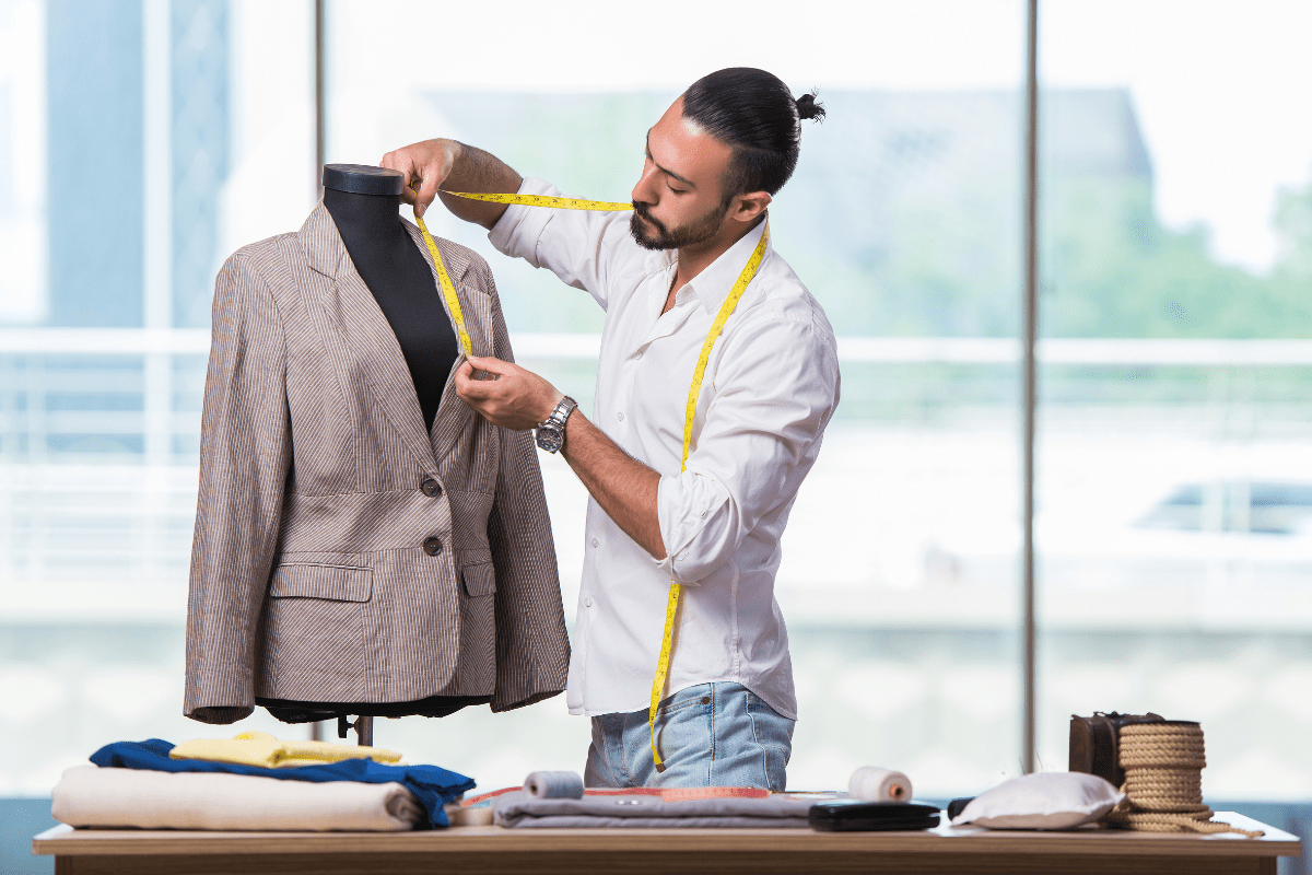 tailor measuring a suit jacket