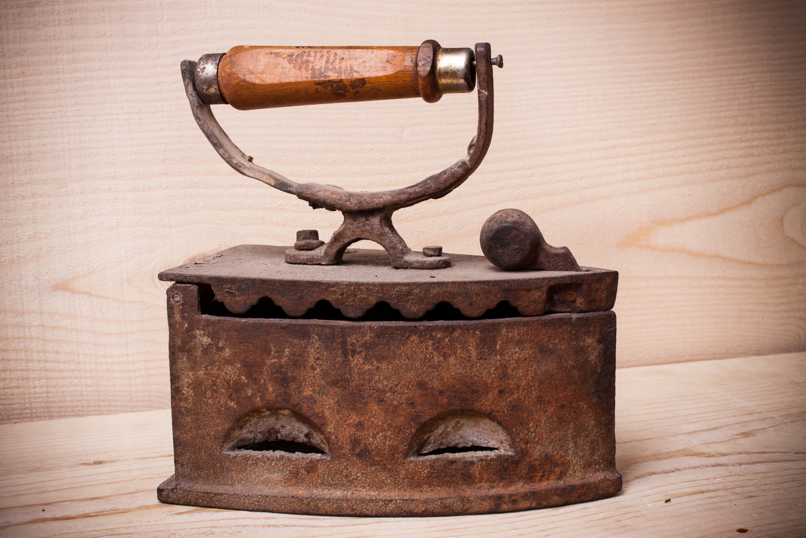 Old rusty iron on top of wood