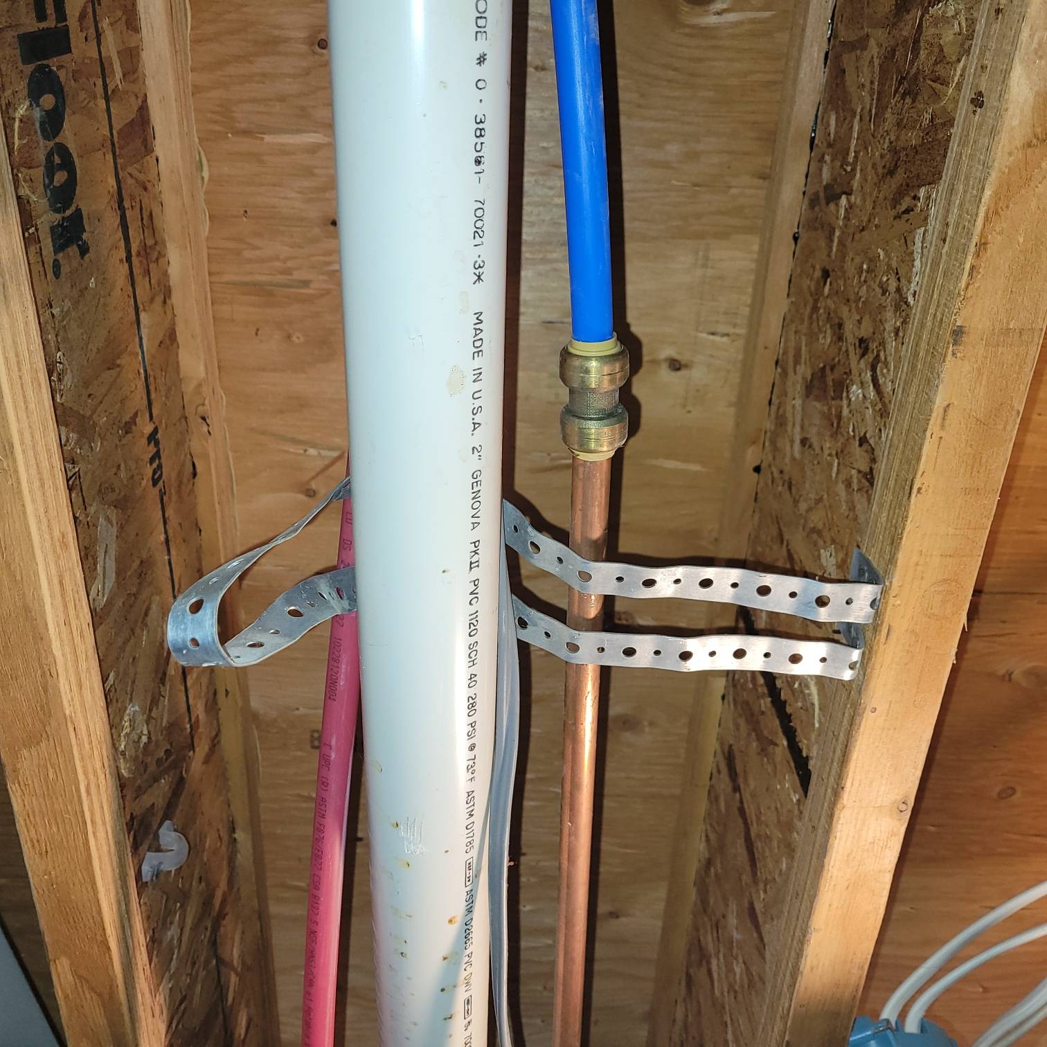 PCV pipe, gas line, and water line running through the basement ceiling.