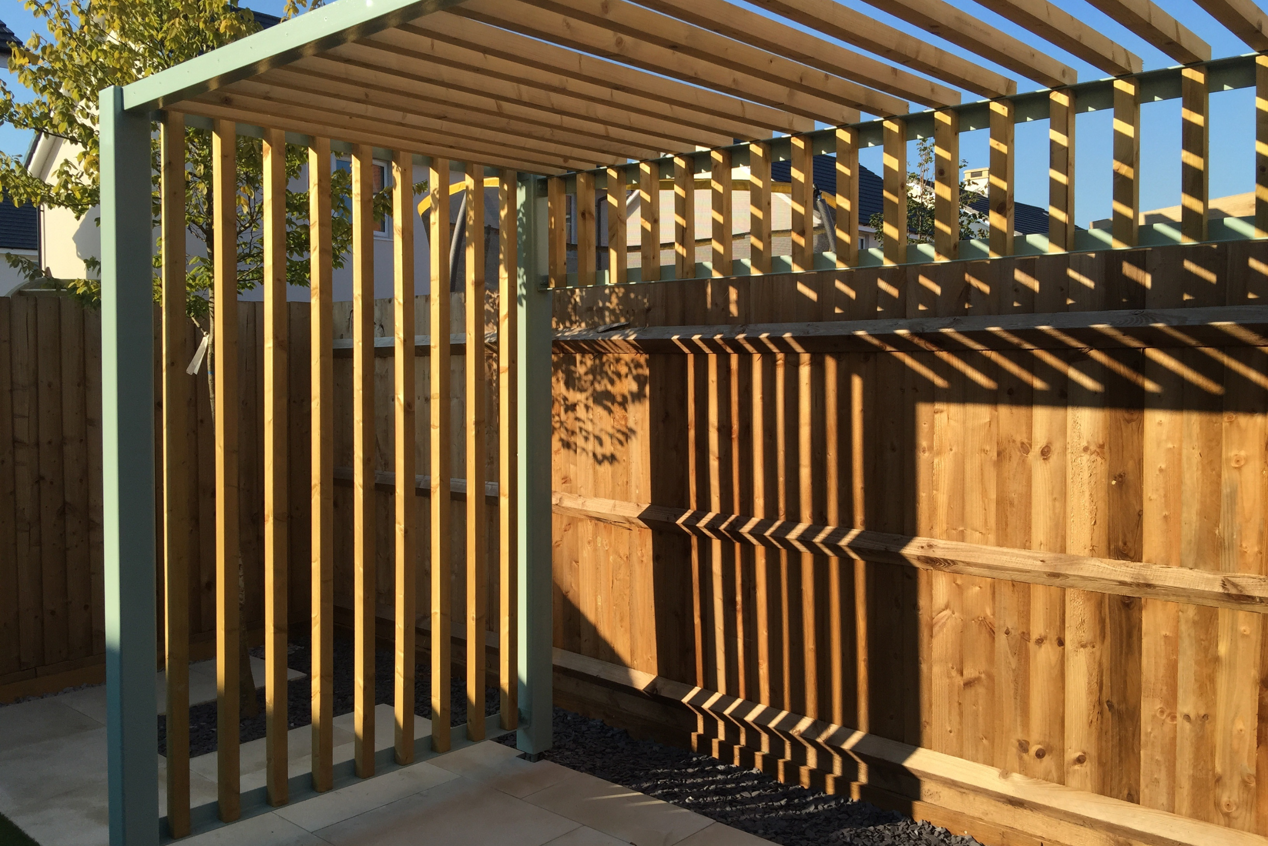 Pergola in backyard causing shadows.