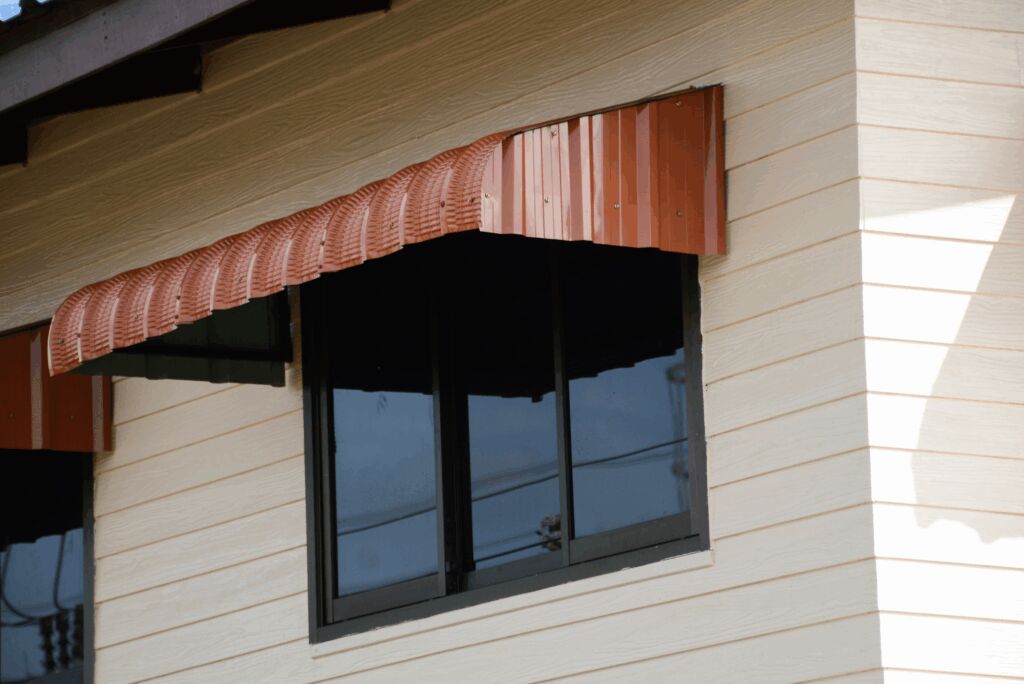 House window covered by metal awning.