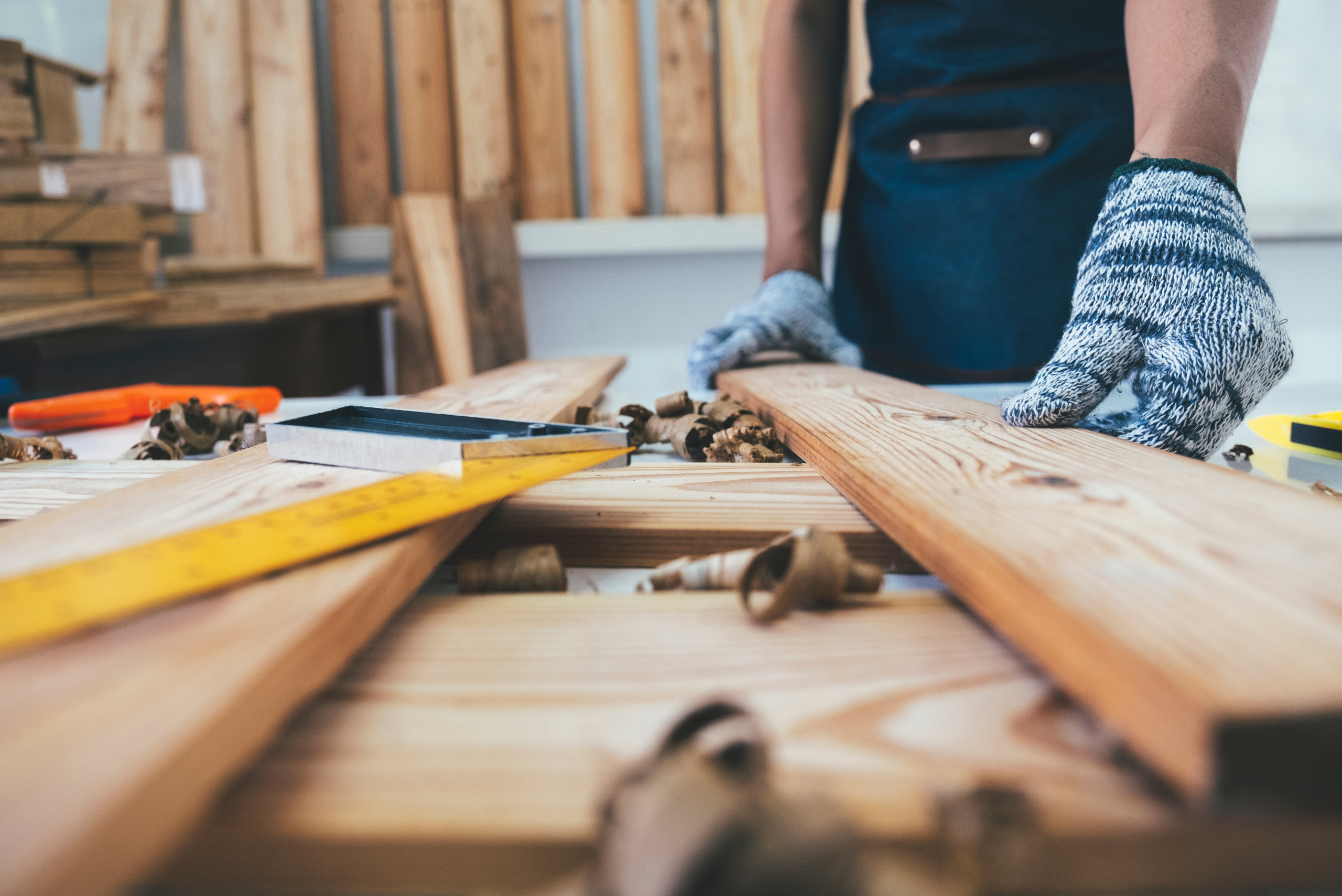 Person grabbing a wooden board.