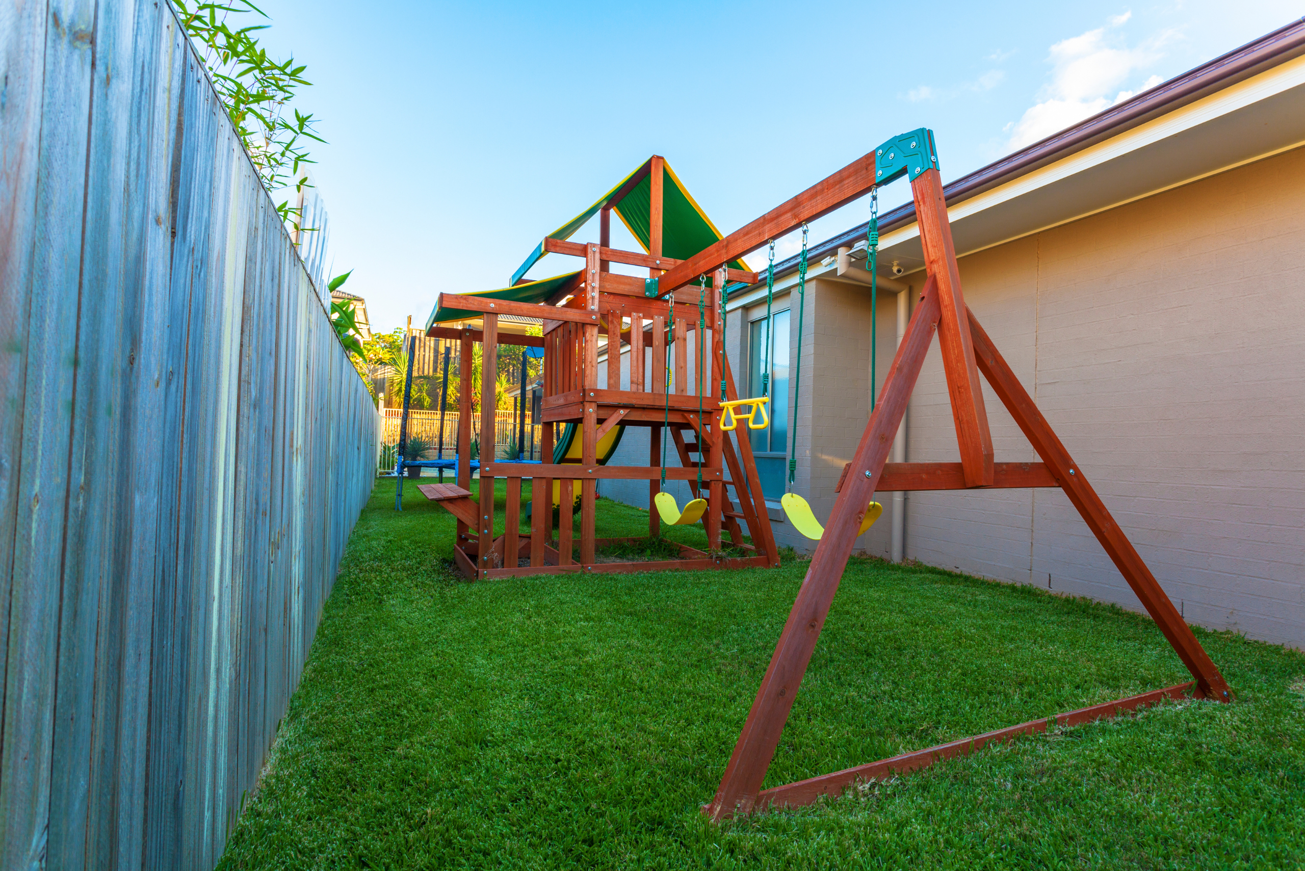 Red wooden swing set.