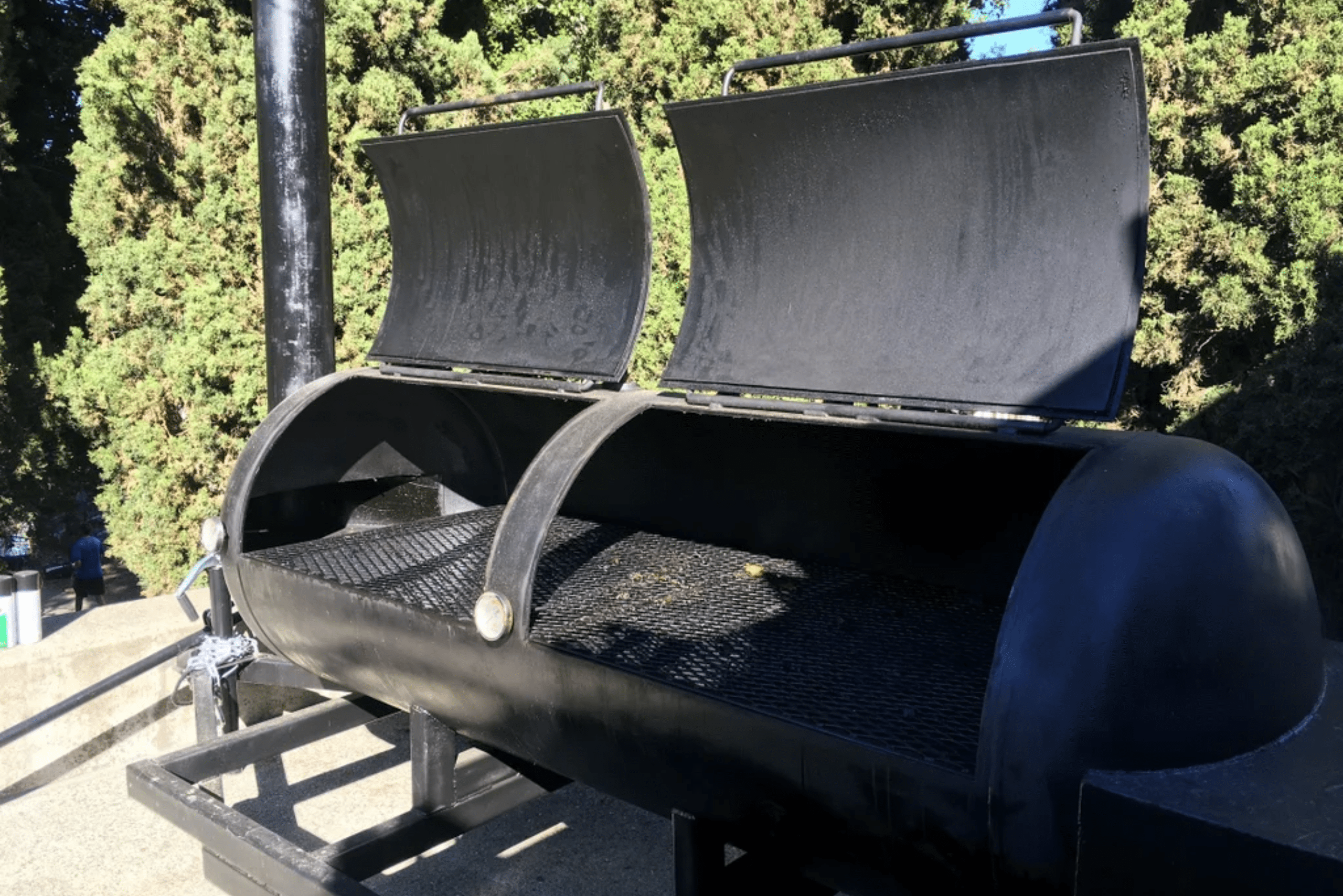 Double smoker with both lids open attached to a trailer.